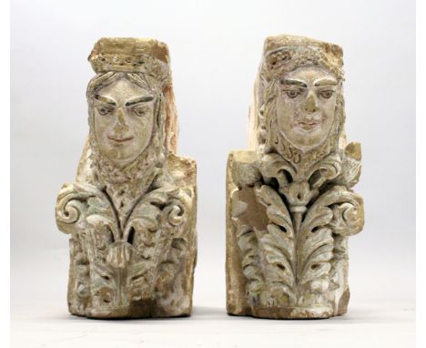 A PAIR OF MEDIEVAL CARVED SANDSTONE CORBELS, each carved with female faces, one with a column capital the other with stylised