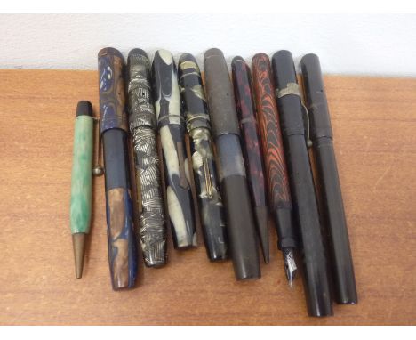 Eight vintage fountain pens and miscellaneous other pen parts.