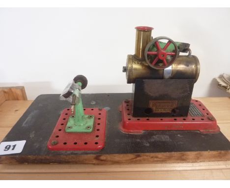 Mamod small static steam engine with grinding wheel on wood base.