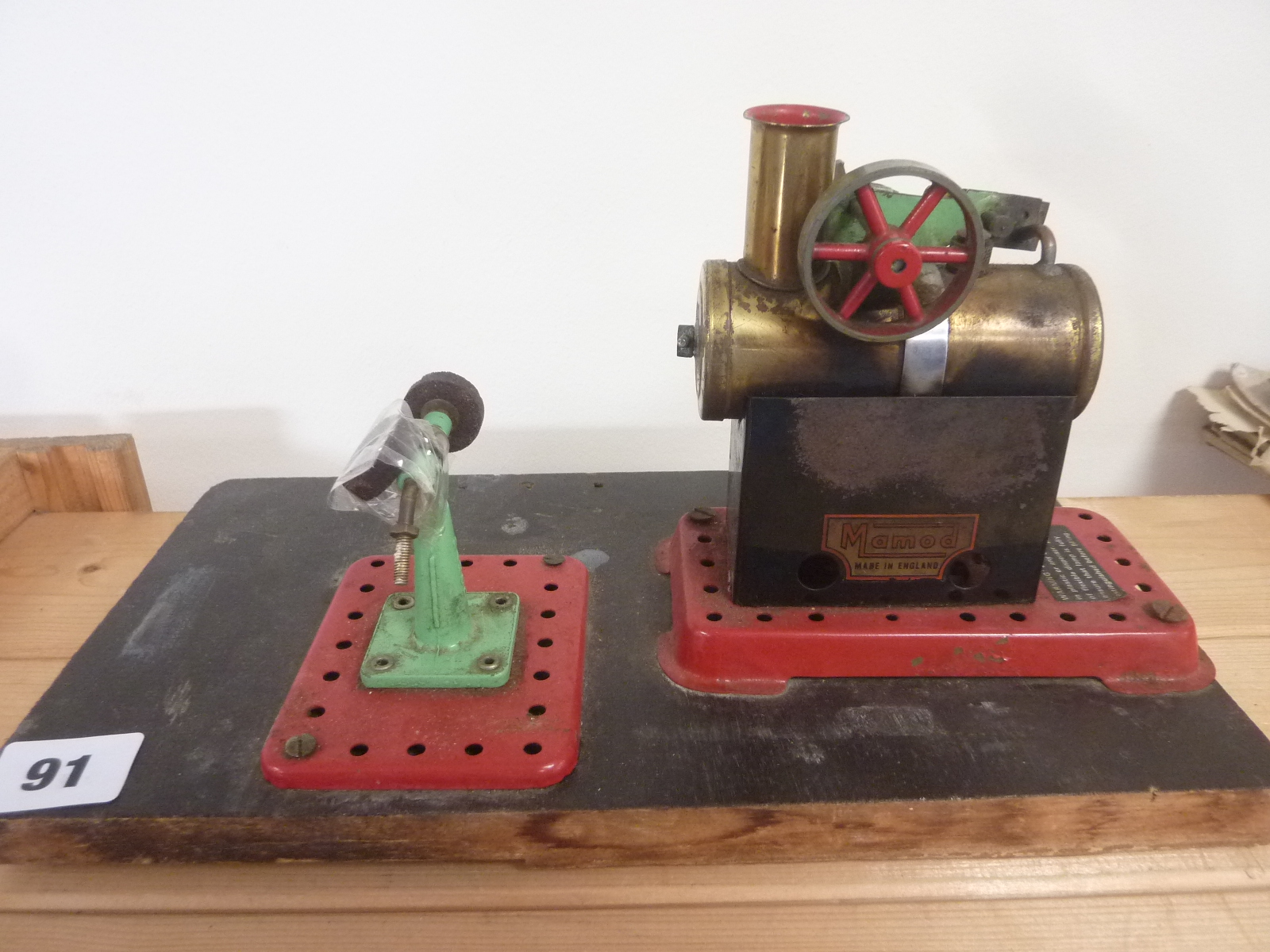 Mamod small static steam engine with grinding wheel on wood base.