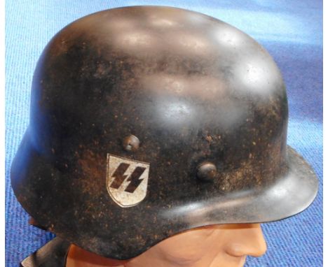 German. Model M35 double decal S.S. steel helmet, with liner. Some light rusting otherwise good condition.