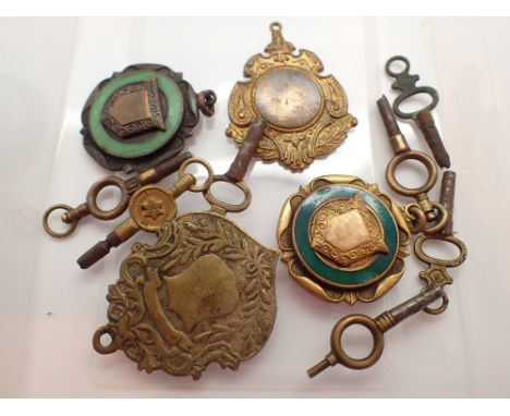 Four fobs and seven vintage pocket watch keys 
