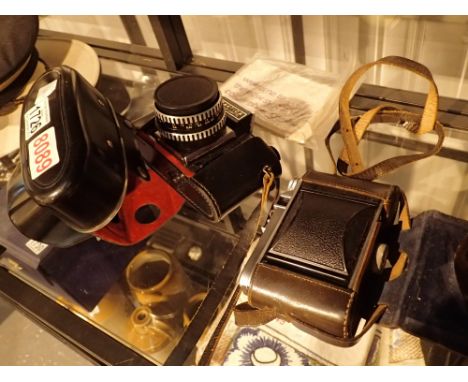 Leather cased Voigtlander Perkeo II camera and a Praktica Super TL example