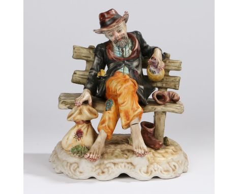 Capodimonte figure, depicting a man sitting on a bench, marked to the base, 25cm high