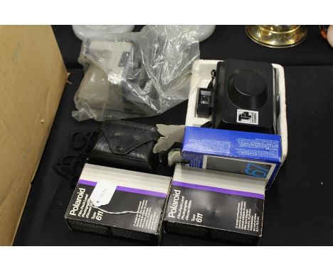 Polaroid camera, together with film also with  button camera
