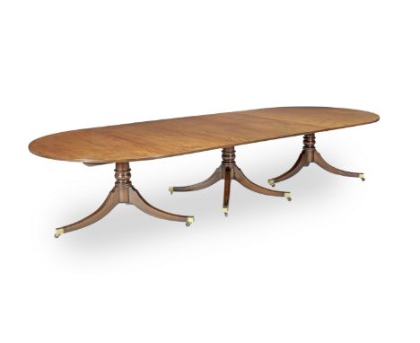 A George III Style Mahogany Triple Pedestal Dining TableEarly 20th century The rounded rectangular top with a reeded edge abo