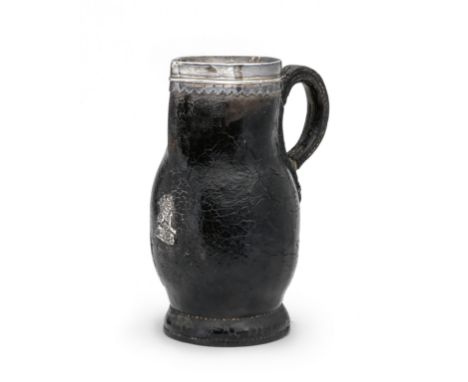 A small 17th century white metal mounted leather blackjack, EnglishWith lambrequin edged rim mount, the bulbous body with por