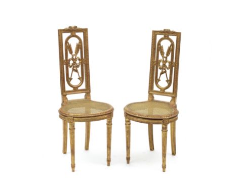 A pair of Louis XVI style giltwood salon chairsLate 19th centuryWith ribbon tied arrow trophy backs above caned seats,  41cm 