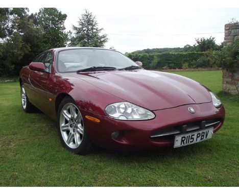 A 1998 Jaguar XK8, registration number R115 PBV, chassis number SAJJGAED3AR021507, engine number CC9711060147, red.  This wel