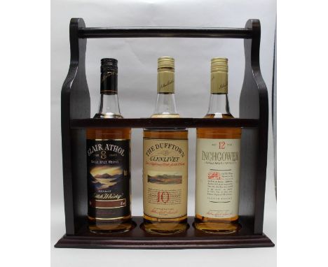 A wooden display caddy containing Blair Athol single malt aged 8 year, The Dufftown Glenlivet single malt aged 10 years, Inch