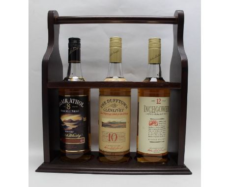 A wooden display caddy containing Blair Athol single malt aged 8 year, The Dufftown Glenlivet single malt aged 10 years, Inch