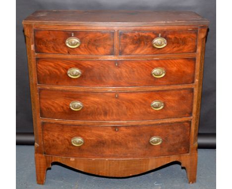 A Victorian mahogany veneered bow front chest of two short and three long graduated cockbeaded drawers on bracket feet, width