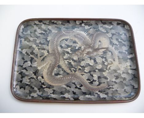 A 19th century Japanese cloisonne tray decorated with a dragon amongst scrolling clouds, the back decorated with five floral 