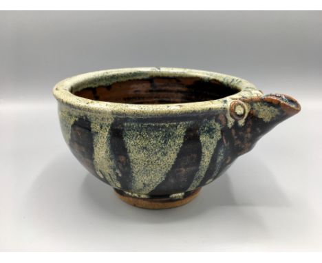 Leach Pottery, St Ives, a Trevor Corser circular, footed bowl with pouring spout, tenmoku glazed to the exterior with stylise