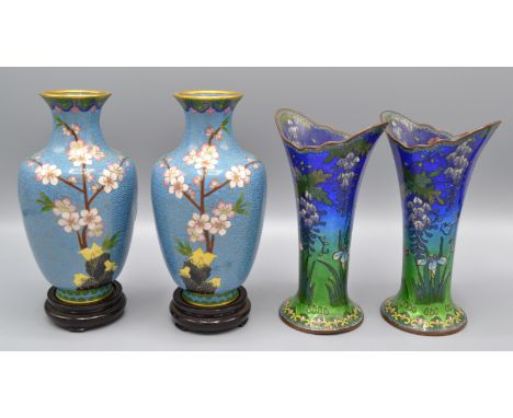 A pair of Chinese cloisonne baluster vases, decorated with flowering prunus and bird in flight on a pale blue ground with all