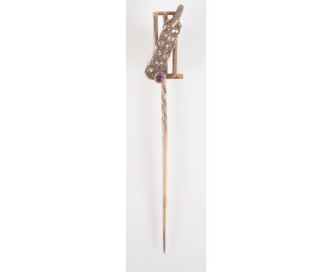 A gold cricketing pin, the finial a white gold cricket bat pave set with diamonds with a ruby ball behind it gold stumps, box