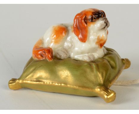 A Royal Worcester porcelain Pekinese on cushion, circa 1908, width 5cm.    Condition report:  Good condition. Some glaze miss