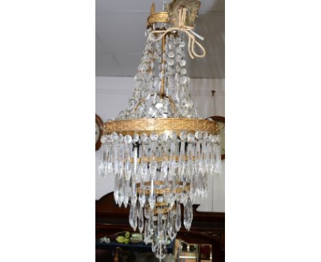 A brass, four tier lustre hung chandelier.