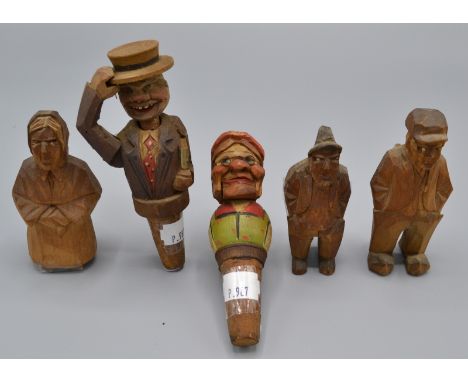 Two ANRI style automaton bottle stoppers, one carved as a gentleman lifting his hat and inclining his head, the other a bespe