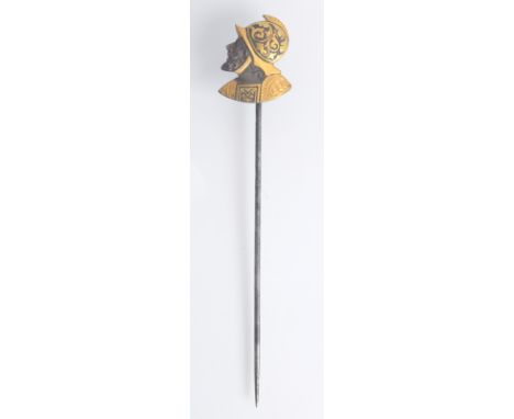 A Spanish 19th century pin, the damascened steel finial in the form of a warrior's head and shoulders.