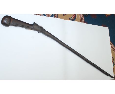 A 19th century middle eastern matchlock rifle, the barrel marked with a crown above a star, lacks ramrod, full length 149cm.