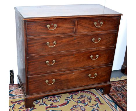 A George III mahogany chest of two short and three long graduated drawers with original brass handles and bracket feet, width