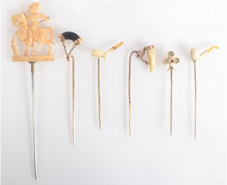 Two pins each with an ivory pipe finial together with four other pins. 