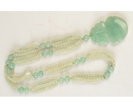 A jade bead necklace with carved jade pendant. 