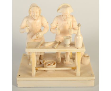 A Dieppe ivory group of a cobbler and his wife, they sit together at a bench surrounded by tools and utensils, width 10cm. 