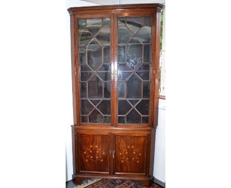 An impressive Georgian style standing corner cabinet, with lattice glaze doors over marquetry doors on bracket feet, height 2