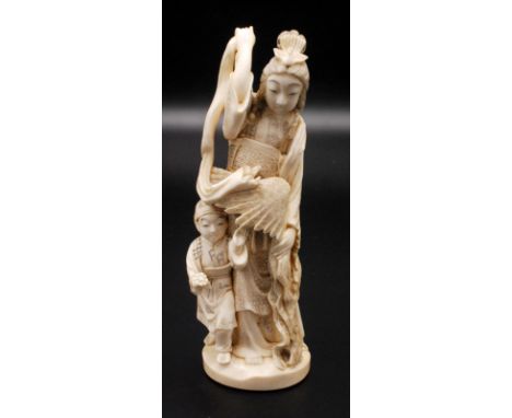 A Japanese ivory okimono, a female symbolising a Tennin or Bhuddhist angel standing holding a hagoromono (feather cloak) and 