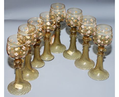 A set of six Bohemian olive-green glass roemers, the bowl enamel decorated with stylised flowerheads on a spiral twist stem a