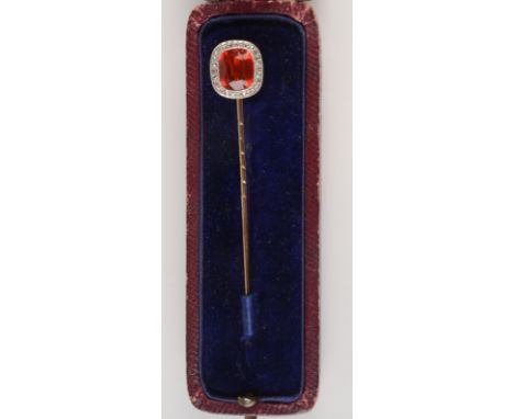 A fine late Victorian or Edwardian gold stick pin, the finial an emerald cut Mexican Fire Opal, surrounded by diamonds.   Con