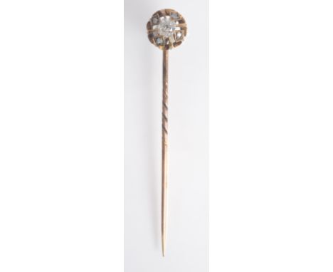 A cage finial pin with a central cushion shaped diamond and small outer diamonds.
