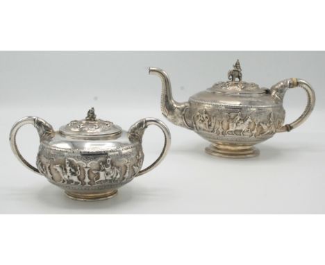 An Indian Bangalore silver teapot and matching sugar bowl by C Krishniah Chetty & Sons, the teapot with a deity riding an ele