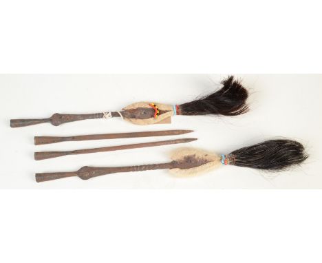 A pair of African arrow heads covered with animal skin, beads and hair, each length 38.5cm, together with two plain iron spea