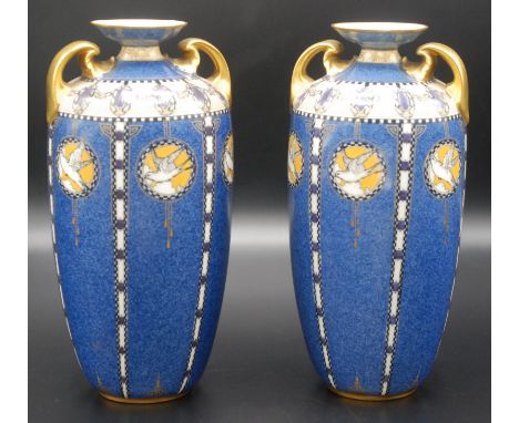 A pair of Royal Worcester powder blue ground, twin handle vases with dove roundels, separated by chequered lines, pattern 270