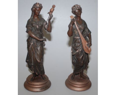 A pair of early 20th century spelter female figures in classical style, one with a lute, the other a staff, height 43cm.