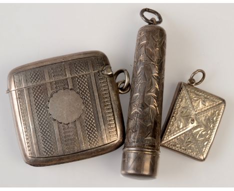 An engine turned Edwardian silver vesta case, an Edwardian silver engraved stamp envelope and a gold mounted amber cigarette 