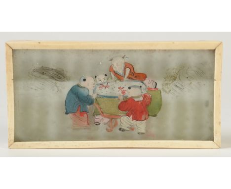 A Japanese bone abacus, fitted to one side with a glass panel painted with four figures around a cooking pot, lines of red ca