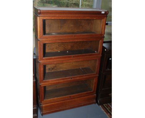 A four section oak bookcase of Globe Wernicke type.