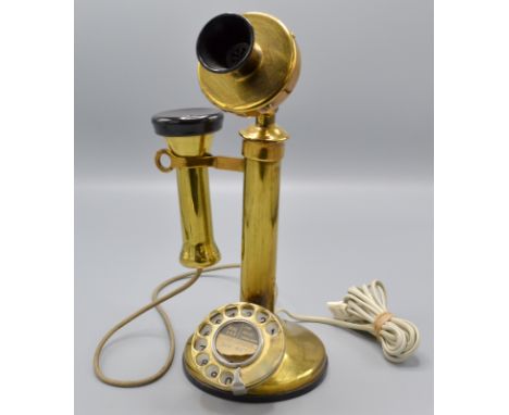 A brass candlestick telephone.