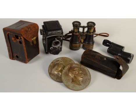 A Microcord twin lens reflex camera in a brown leather case, a pair of binoculars, a monocular and a pair of Victorian and Al