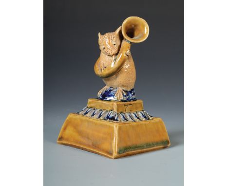 A George Tinworth, Doulton Lambeth musician, the mouse stands playing a large horn on stepped square acanthus moulded base da