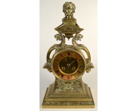 An ornate French brass cased mantle clock, the movement by Raingo, Paris, the finial with an heroic female bust supported on 