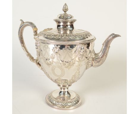 A good Victorian plated tea pot with swags and mask, the lid with a pineapple finial, height 24cm.