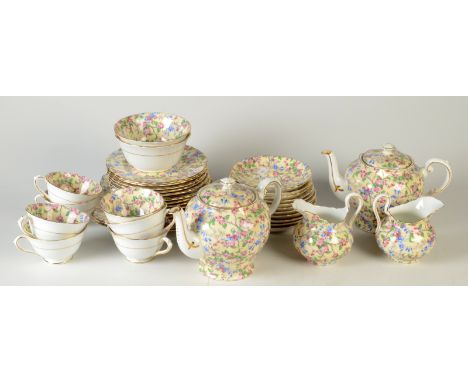 A Tuscan chintz tea service, comprising two teapots, two large plates, twelve side plates, seven cups, eleven saucers, two cr