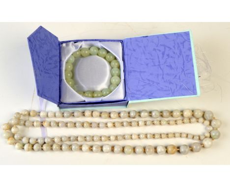 A green jade bead bracelet and a grey jade graduated bead necklace.