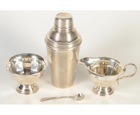 A 1930s engine turned cocktail shaker and three other pieces.