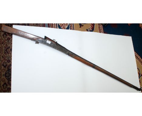 A 20th century Indian matchlock rifle the stock dated 1935, the barrel with a flared muzzle, full length 163cm.